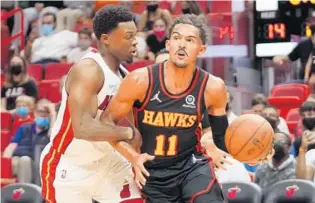  ?? MARK BROWN/GETTY ?? Kyle Lowry, left, guards Trae Young on Monday. Lowry is crafting an intriguing Heat plotline as he adjusts to the Heat.