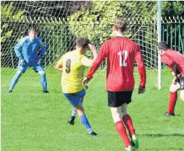  ??  ?? Black Cock’s Daniel Conway, yellow strip, opens the scoring for Black Cock against Red Lion Hartshill, while right, Jack Kinsey scored the first of his three goals. Pictures: Steve Bould