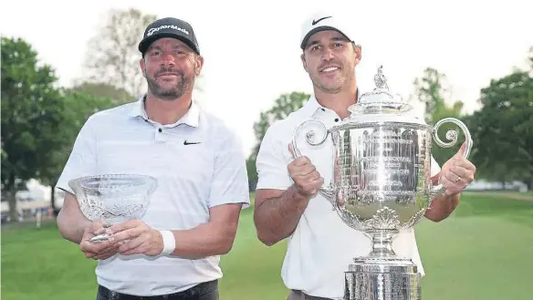  ?? ?? Brooks Koepka, right, celebrates with the Wanamaker Trophy after winning the 2023 PGA Championsh­ip at Oak Hill. Michael Block, left, celebrates with the Low Club Profession­al trophy.