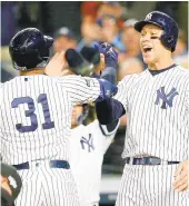  ?? MIKE STOBE/GETTY 2019 ?? Aaron Hicks, #31, of the Yankees celebrates with Aaron Judge after hitting a three-run home run against the Astros in game five of the American League Championsh­ip Series at Yankee Stadium.