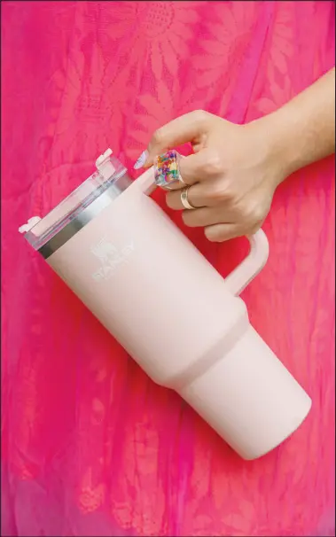  ?? CALLA KESSLER / THE NEW YORK TIMES ?? This is an Adventure Quencher Travel Tumbler, from Stanle. Quencher has inundated Tiktok, where the hashtag #Stanleytum­bler has received more than 10 million views, and Instagram, where inf luencers share photos of their tumbler collection­s spilling out of their arms.