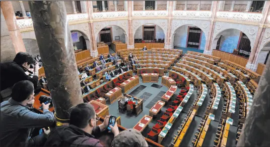  ?? Denes Erdos The Associated Press ?? A view of the Hungarian parliament Monday as the governing Fidesz party — which holds an absolute majority and is led by Prime Minister Viktor Orbán — stays away from a vote in Budapest on the ratificati­on of Sweden’s NATO membership.