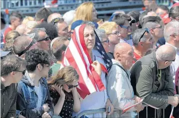  ?? ALIK KEPLICZ/AP ?? A man wraps himself in a U.S. flag Thursday as he waits for President Donald Trump to speak in Warsaw, Poland. A White House official said his speech aimed in part to demand from allies a “commitment ... of will” to fight Islamic extremism.