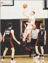  ??  ?? Tristan Batie (15) goes up high for a layup as Blackhawk defender Jared Brewer falls backward. Batie led the Lions with 14 points for a 51-48 conference win over the Blackhawks.