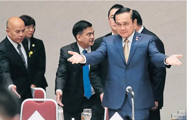  ?? EPA/KIMIMASA MAYAMA ?? Prime Minister Prayut Chan-o-cha gestures to executives of the Japan Business Federation to sit down as he arrives at a luncheon held at the federation’s headquarte­rs during his three-day visit.