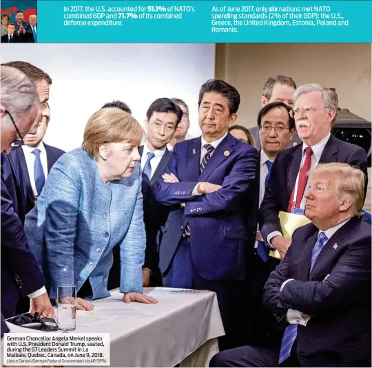  ?? (Jesco Denzel/German Federal Government via AP/SIPA) ?? German Chancellor Angela Merkel speaks with U.S. President Donald Trump, seated, during the G7 Leaders Summit in La Malbaie, Quebec, Canada, on June 9, 2018.