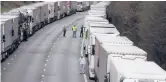  ?? WIGGLESWOR­TH/AP KIRSTY ?? Freight trucks are parked Tuesday while the Port of Dover remains closed in southern England amid new coronaviru­s restrictio­ns.