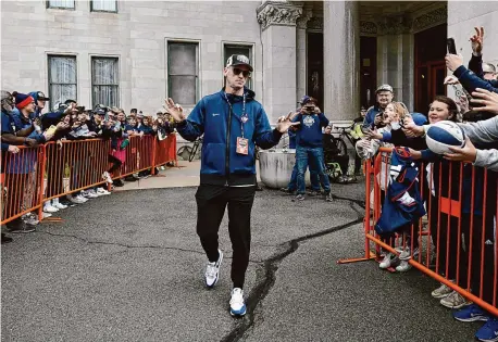  ?? Jessica Hill/Associated Press ?? UConn head coach Dan Hurley greets fans during a parade to celebrate the team’s NCAA college basketball championsh­ip Saturday in Hartford.
