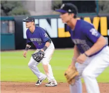  ?? JIM THOMPSON/ JOURNAL ?? Albuquerqu­e’s Shawn O’Malley, left, moves into position just before a pitch during Saturday’s home game against Las Vegas. The skidding Isotopes lost 7-5.