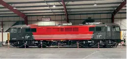  ?? James Mather ?? Sparkling from its repaint into Virgin Trains red and grey livery, 87035 stands in the exhibition hall at Crewe Heritage Centre, awaiting the applicatio­n of its Robert Burns nameplates.