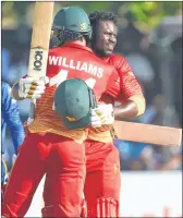  ??  ?? Zimbabwe's Solomon Mire (R) celebrates after scoring his century with Sean Williams during the first ODI against Sri Lanka at the Galle Internatio­nal Cricket Stadium on Friday.