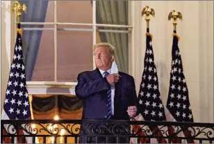  ?? Nicholas Kamm AFP/Getty Images ?? BACK AT the White House after hospitaliz­ation for COVID-19, President Trump removed his mask, a clear signal to his core supporters, whose desires he has never willingly neglected.