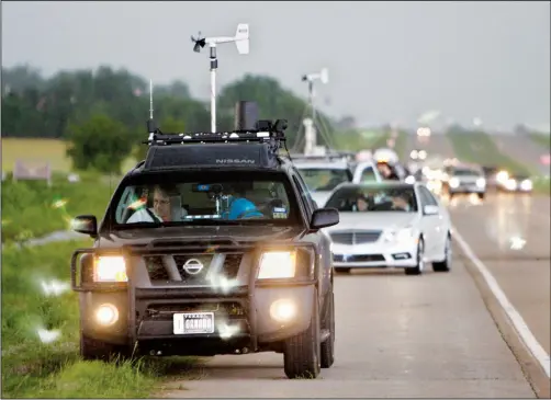 ?? (File Photo/AP/Sue Ogrocki) ?? Storm chasers and spectator vehicles clog the road and shoulder of a highway May 19, 2010, near Kingfisher, Okla.