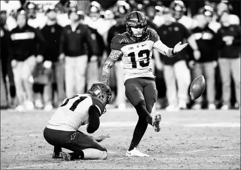  ?? AJ MAST/AP PHOTOS ?? Purdue placekicke­r Spencer Evans (13) boots the winning field goal against Iowa on Saturday.