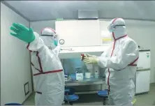  ?? YANG DI / CHINA NEWS SERVICE ?? Research workers disinfect after finishing a test at a biosafe laboratory in Yinchuan, Ningxia Hui autonomous region, in April. The lab is mainly for testing dangerous pathogens.