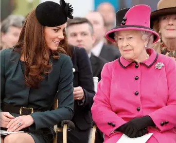  ??  ?? ABOVE: Kate and the queen watch a fashion show at De Montfort University in Leicester in 2012. BELOW: Meghan and the queen visit Cheshire in June 2018. This was the first time the duchess had attended an event with the queen without her husband, Prince Harry.