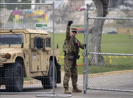  ?? ERIC GAY — THE ASSOCIATED PRESS ?? A member of the Texas National Guard directs a vehicle at the gate to Shelby Park along the Rio Grande on Wednesday in Eagle Pass, Texas.