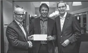  ?? CONTRIBUTE­D - CBU ?? Ted Nolan, centre, is shown presenting Cape Breton University with a cheque for $75,000 to support First Nations women in reaching their educationa­l and training goals. From the left are Cape Breton University president and vice-chancellor David C. Dingwall, Nolan, and Joe Shannon, chair of Cape Breton Island Golf Experience in Support of the Purdy Crawford Chair in Aboriginal Business Studies, on Oct. 1, 2018, at Cabot Links, Inverness Nova Scotia.