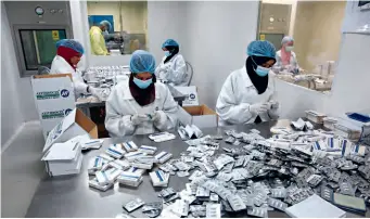  ?? ?? Locals work in a China-sudan pharmaceut­ical joint venture facility in Khartoum North, Sudan, on April 25