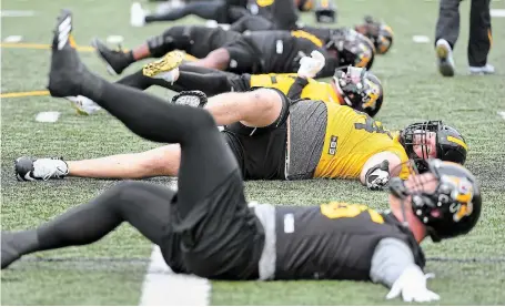  ?? BARRY GRAY THE HAMILTON SPECTATOR FILE PHOTO ?? Veteran lineman Chris Van Zeyl, second from bottom, during the last training camp held at McMaster in May 2019. He’s been keeping busy communicat­ing the labour situation to the Tiger-Cats players and hopefuls currently on campus.
