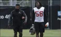  ?? AP PHOTO/JEFF CHIU ?? San Francisco 49ers linebacker Reuben Foster (56) walks on the field with assistant coach Ray Wright during a practice at the team’s NFL football training facility in Santa Clara, on Wednesday.