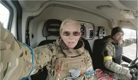  ?? YULIIA PAIEVSKA ?? Medic Yuliia Paievska and her driver Serhiy sit in a vehicle in Mariupol, Ukraine, on March 9. She was last seen March 21 on Russian television.