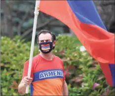  ?? Tyler Sizemore / Hearst Connecticu­t Media ?? Greenwich’s Robert Stepanian waves an Armenian flag as Amenian supporters rally Wednesday against the ongoing conflict between Armenia and Azerbaijan.