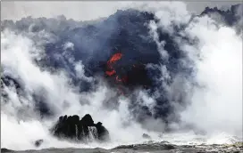  ?? MARIO TAMA / GETTY IMAGES ?? A steam plume rises as lava enters the Pacific Ocean, after flowing to the water from a Kilauea volcano fissure, on Hawaii’s Big Island on Sunday near Pahoa, Hawaii. Officials are concerned that “laze,” a dangerous product produced when hot lava hits...