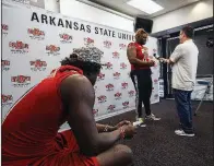  ?? Arkansas Democrat-Gazette/MITCHELL PE MASILUN ?? ASU safety Michael Johnson (left) waits his turn Thursday while Andrew Harris Jr. speaks at the team’s media day.