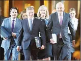  ?? (AP) ?? New Zealand Finance Minister Steven Joyce (right), walks with Prime Minister Bill English (center), to present his Budget 2017 at Parliament, Wellington, New Zealand on May 25. New Zealand’s conservati­ve government is planning to reduce taxes and spend...