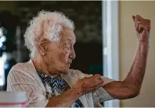  ??  ?? Ofelia Gonzales, 108, demonstrat­es to her three granddaugh­ters at their monthly gathering that she still can hold her own.