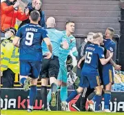  ?? ?? REACTION Aberdeen team-mates guide Ojo away from United fans