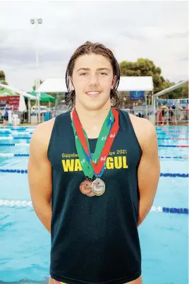  ?? ?? Callum Halloran-Lavelle wears a heavy bundle of medals after seven podium finishes, including one gold in the Boys 16-17 100m backstroke.