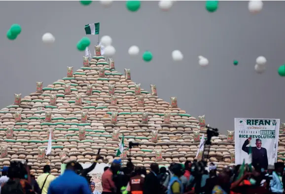  ?? ?? The Rice Farmers Associatio­n of Nigeria (RIFAN) builds 15 pyramids in Abuja with bags filled with rice harvested across the country on January 18, 2022. The objective of the event is to call for public action to solve the nation’s food crisis.