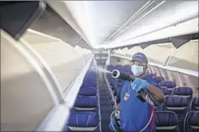  ?? Provided by Southwest Airlines ?? A worker is shown cleaning and disinfecti­ng the inside of a Southwest Airlines jet as part of the airline’s promise to employees and passengers.