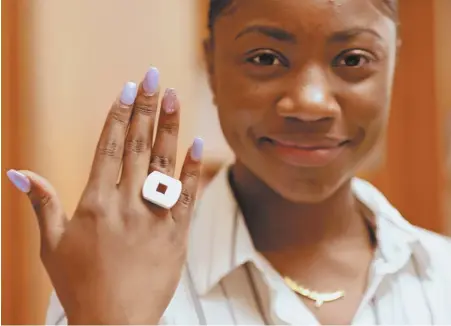  ?? STAFF PHOTOS BY ANGELA ROWLINGS ?? NICE RING TO IT: Hallie Dubuisson, 16, above, shows a 3D printed ring. At right, from left, Dubuisson, 16, Eliza Daniel, 16, and Ashanti Tejada, 15, worked on the ring project they call ‘Divergent.’