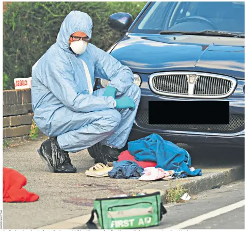  ??  ?? A police forensic worker stands over blood-covered clothing at the scene of an alleged hammer attack on two women in south-east London