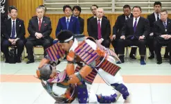  ?? —AP ?? TOKYO: Russian President Vladimir Putin (3rd R), Japanese Prime Minister Shinzo Abe (3rd L), former Japanese Prime Minister Yoshiro Mori (2nd L) and vice chairman of the All Japan Judo Federation Yasuhiro Yamashita (2nd R) watch a demonstrat­ion of...