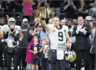  ?? Butch Dill ?? The Associated Press New Orleans quarterbac­k Drew Brees responds to the crowd after breaking the NFL all-time passing yards record in the first half of the Saints’ 43-19 victory Monday in the Mercedes-benz Superdome.
