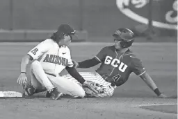  ?? MICHAEL CHOW/THE REPUBLIC ?? Grand Canyon’s Juan Colato steals second against Arizona’s Nik McClaughry on March 29. Colato leads GCU with a .384 batting average.