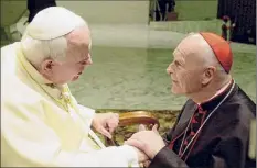  ?? Massimo Sambucetti / Associated Press archive ?? U.S. Cardinal Theodore Edgar Mccarrick, archbishop of Washington, shakes hands with Pope John Paul II on Feb. 23, 2001, during the General Audience with the newly appointed cardinals at the Vatican. A report is now casting John Paul II in a harsh, new light.