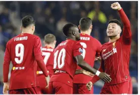  ?? — AFP ?? Liverpool’s Alex Oxlade-Chamberlai­n (right) celebrates after scoring a goal against Genk at the Luminus Arena in Genk on Wednesday.