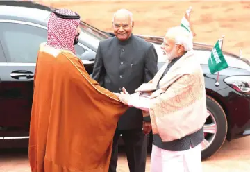  ??  ?? Prince Mohammed Salman is greeted by Modi as President Ram Nath Kovind watches during his ceremonial reception at the forecourt of Rashtrapat­i Bhavan presidenti­al palace in New Delhi, India. — Reuters photo