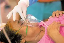  ?? —AFP ?? LIFEGIVING A patient breathes with the help of oxygen provided by a gurdwara, a place of worship for Sikhs, under a tent installed along the roadside amid the COVID-19 pandemic on the outskirts of New Delhi, India, on May 10.