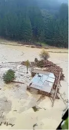  ??  ?? ABOVE RIGHT: A rescue chopper closes in on a family on the roof of their Tolaga Bay home, surrounded by floodwater­s and forestry debris, on June 4.