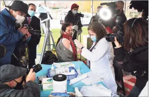  ?? Brian A. Pounds / Hearst Connecticu­t Media ?? Surrounded by the media, Dr. Corina Marcu, from St. Vincent's Medical Center in Bridgeport, receives one of the first fifteen doses of the Pfizer Covid-19 vaccine from Colleen Teevanat Hartford Hospital on Monday.