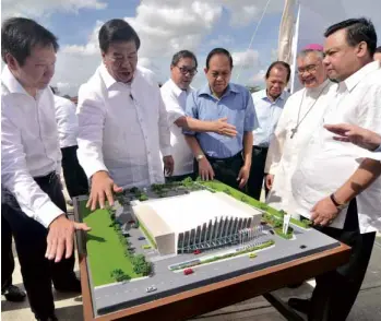  ??  ?? ILOILO CONVENTION CENTER Senator Franklin Drilon and Tourism Secretary Ramon Jimenez Jr. (second and third from left) check out the scale model of the proposed Iloilo Convention Center, which was unveiled recently at the Iloilo Business Park. With them...