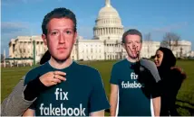  ?? PHOTO: AP ?? Sofia Latif, right, and Nell Greenberg of the advocacy group, Avaaz, install lifesized cutouts depicting Facebook chief executive Mark Zuckerberg wearing "Fix Fakebook" T-shirts on the southeast lawn of the Capitol in Washington yesterday.