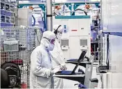  ?? CONTRIBUTE­D ?? Employees wearing clean room “bunny suits” work at Intel’s D1X factory in Hillsboro, Oregon.