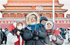  ?? ?? Tourists visit Tiananmen Square in Beijing during the December cold snap